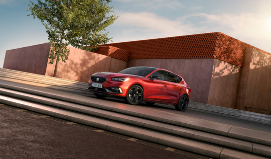 Roter SEAT Leon Blackedition parkend auf einer Fläche zwischen Treppenstufen.